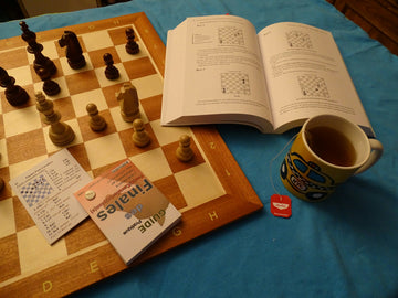 Chess set with chess puzzle book open