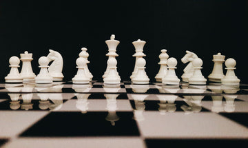 Low shot of white chess pieces on a board-sk-unsplash
