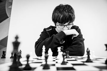 Young man focusing over the chess board- michal-vrba-unsplash